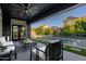Covered patio with stylish seating, ceiling fan, and stunning view of the pool at 3145 E Boot Track Trl, Gilbert, AZ 85296