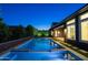 Beautiful backyard with a sparkling pool, elegant landscaping, and a modern home exterior at 3145 E Boot Track Trl, Gilbert, AZ 85296