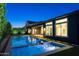 Stunning backyard featuring a modern pool, lush greenery, and an inviting outdoor living space at 3145 E Boot Track Trl, Gilbert, AZ 85296