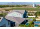 A rear view of a home showcasing a lush backyard, modern pool, and expertly manicured greenery at 3145 E Boot Track Trl, Gilbert, AZ 85296