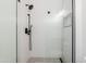 Modern bathroom with a glass enclosed shower, gray tile floor, and black shower hardware at 3145 E Boot Track Trl, Gilbert, AZ 85296
