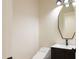 Modern powder room with a sleek vanity, unique mirror, and a contemporary toilet at 3145 E Boot Track Trl, Gilbert, AZ 85296