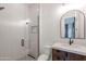 Updated bathroom featuring glass enclosed shower and vanity with wood cabinets and white counter at 3145 E Boot Track Trl, Gilbert, AZ 85296