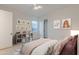 Cozy bedroom with a playful decor, a large window and soft, neutral tones at 3145 E Boot Track Trl, Gilbert, AZ 85296