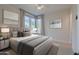 Cozy bedroom with ambient lighting, neutral tones, and large windows for natural light at 3145 E Boot Track Trl, Gilbert, AZ 85296