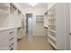 Spacious walk-in closet with custom shelving and drawers for organized storage at 3145 E Boot Track Trl, Gilbert, AZ 85296