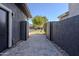 The paved driveway provides access to a side yard with a gated entry to the backyard at 3145 E Boot Track Trl, Gilbert, AZ 85296