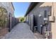 Paver driveway leads alongside the house, highlighting the home's utility access at 3145 E Boot Track Trl, Gilbert, AZ 85296