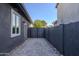 Paver driveway leads to a private side yard and access gate in a modern style at 3145 E Boot Track Trl, Gilbert, AZ 85296