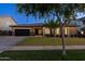 Inviting home featuring manicured landscaping, a modern exterior, and a spacious driveway leading to a garage at 3145 E Boot Track Trl, Gilbert, AZ 85296