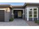 Inviting front entrance with decorative columns, a bay window, and a brick-paved walkway at 3145 E Boot Track Trl, Gilbert, AZ 85296
