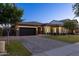 Elegant home with a well-maintained lawn, a welcoming entrance, and a spacious driveway leading to a two-car garage at 3145 E Boot Track Trl, Gilbert, AZ 85296