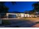 Inviting home exterior with soft holiday lights and a brick driveway, showcasing elegance at 3145 E Boot Track Trl, Gilbert, AZ 85296