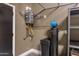 Garage featuring a wall mounted water heater and water conditioning equipment at 3145 E Boot Track Trl, Gilbert, AZ 85296