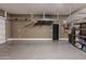 Garage featuring painted walls, shiny epoxy floor and ceiling mounted storage racks at 3145 E Boot Track Trl, Gilbert, AZ 85296