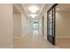 Open hallway with modern lighting and a stylish sliding glass door, enhancing the spacious feel at 3145 E Boot Track Trl, Gilbert, AZ 85296