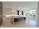 Gourmet kitchen featuring island with quartz countertop, stainless appliances, and spacious design at 3145 E Boot Track Trl, Gilbert, AZ 85296