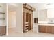 Modern kitchen featuring custom wood cabinets with shelving, a spacious island, and ample storage at 3145 E Boot Track Trl, Gilbert, AZ 85296