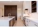 Modern kitchen featuring stainless steel appliances, spacious island, and a combination of wood and white cabinetry at 3145 E Boot Track Trl, Gilbert, AZ 85296