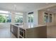 Open concept kitchen features an island with quartz countertops and stainless steel appliances at 3145 E Boot Track Trl, Gilbert, AZ 85296
