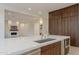 Well-appointed kitchen featuring island with quartz countertop and stainless steel appliances at 3145 E Boot Track Trl, Gilbert, AZ 85296
