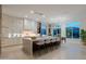 Modern kitchen with a large island, sleek countertops, stainless steel appliances, and an adjacent breakfast nook at 3145 E Boot Track Trl, Gilbert, AZ 85296