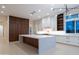 Spacious kitchen featuring an island, custom cabinets, and modern lighting fixtures at 3145 E Boot Track Trl, Gilbert, AZ 85296
