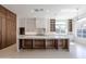 Modern kitchen featuring custom wood cabinets, a spacious island with seating, and storage beneath at 3145 E Boot Track Trl, Gilbert, AZ 85296