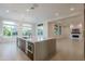 Open concept kitchen features an island with quartz countertops and stainless steel appliances at 3145 E Boot Track Trl, Gilbert, AZ 85296
