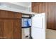 Kitchen with built in ice maker featuring custom wood cabinets, and ample storage at 3145 E Boot Track Trl, Gilbert, AZ 85296