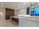 Bright kitchen featuring an island, custom cabinets, and modern lighting fixtures at 3145 E Boot Track Trl, Gilbert, AZ 85296