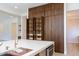 Modern kitchen featuring custom wood cabinets with shelving, a spacious island, and ample storage at 3145 E Boot Track Trl, Gilbert, AZ 85296