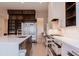 Spacious kitchen with open refrigerator, large island and modern white cabinets at 3145 E Boot Track Trl, Gilbert, AZ 85296