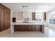 Modern kitchen featuring custom wood cabinets, a spacious island with seating, and stainless steel appliances at 3145 E Boot Track Trl, Gilbert, AZ 85296