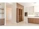 Modern kitchen featuring custom wood cabinets, a spacious island, and ample storage, doors open at 3145 E Boot Track Trl, Gilbert, AZ 85296