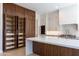 Modern kitchen featuring custom wood cabinets with shelving, a spacious island, and ample storage at 3145 E Boot Track Trl, Gilbert, AZ 85296