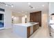 Open-concept kitchen with a large island, stainless steel appliances, and stylish gold fixtures at 3145 E Boot Track Trl, Gilbert, AZ 85296