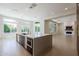Open-concept kitchen and living room with granite countertops, a large island, and modern appliances at 3145 E Boot Track Trl, Gilbert, AZ 85296