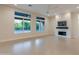 Bright living room boasts fireplace, modern lighting, and large windows showcasing lush landscaping at 3145 E Boot Track Trl, Gilbert, AZ 85296