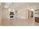 Bright, open-concept living room with fireplace, modern ceiling fan, and view of the hallway and front entry at 3145 E Boot Track Trl, Gilbert, AZ 85296