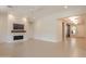 Bright, open living room with fireplace, modern ceiling fan, and expansive space for living and entertaining at 3145 E Boot Track Trl, Gilbert, AZ 85296