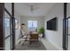 Modern home office with sleek desk, wall mounted TV, and a bright airy feel at 3145 E Boot Track Trl, Gilbert, AZ 85296