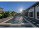 Backyard view of the glistening pool with water feature, surrounded by lush landscaping and patio space at 3145 E Boot Track Trl, Gilbert, AZ 85296