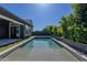A sparkling pool is surrounded by lush greenery, providing a tranquil backyard oasis at 3145 E Boot Track Trl, Gilbert, AZ 85296