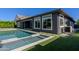 Backyard pool features a spa and shallow sunbathing area surrounded by green space at 3145 E Boot Track Trl, Gilbert, AZ 85296