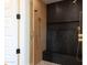 Stylish shower with gold fixtures, black tile accents, and a built-in bench at 3145 E Boot Track Trl, Gilbert, AZ 85296
