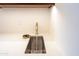 Modern wet bar features a gold faucet, a glass rinser, and a stainless steel sink at 3145 E Boot Track Trl, Gilbert, AZ 85296