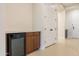 A compact wet bar with wine fridge, wood cabinets, and white countertop at 3145 E Boot Track Trl, Gilbert, AZ 85296