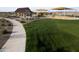Sidewalk winds through a lush community park leading to covered picnic areas and playgrounds at 32243 N Garnet Way, San Tan Valley, AZ 85143