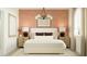 This main bedroom features a large bed, soft lighting, and a decorative accent wall at 32243 N Garnet Way, San Tan Valley, AZ 85143